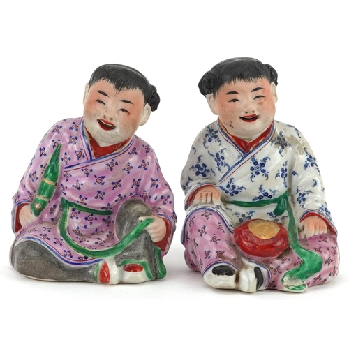 1325 - Pair of Chinese porcelain figures of children wearing robes, the largest 9.5cm high