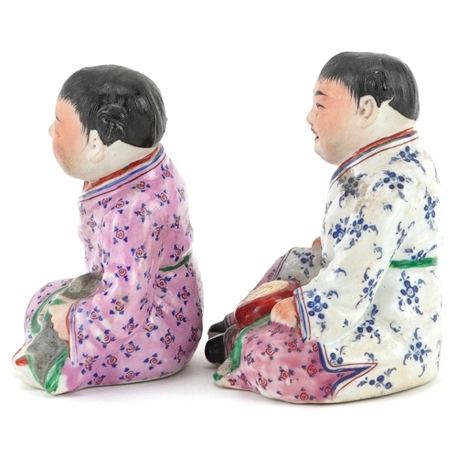 1325 - Pair of Chinese porcelain figures of children wearing robes, the largest 9.5cm high