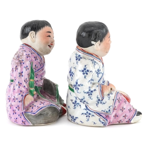 1325 - Pair of Chinese porcelain figures of children wearing robes, the largest 9.5cm high