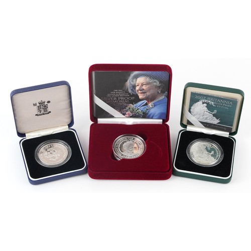 1669 - Three silver proof coins with cases including 2007 Britannia two pound and Memorial crown