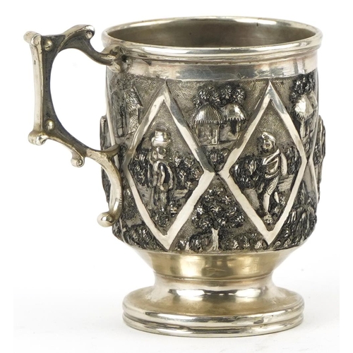 136 - Grish Chunder of Calcutta, Indian unmarked silver christening tankard embossed with villagers and ga... 