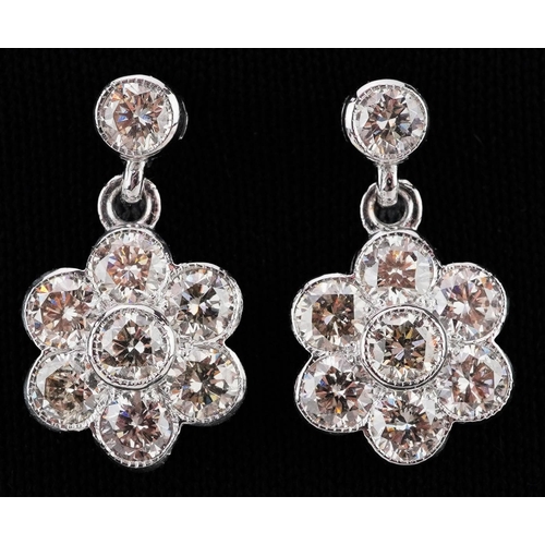 2031 - Pair of 18ct white gold round brilliant cut diamond flower head drop earrings, total diamond weight ... 