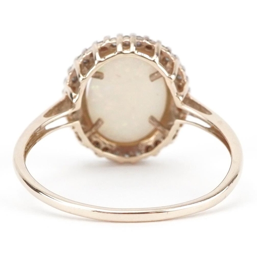 2083 - 9ct gold cabochon opal and diamond halo ring, size S, 1.8g