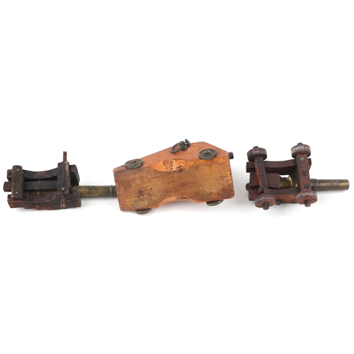 34 - Three 19th/20th century military interest patinated bronze  and hardwood table cannons, the largest ... 