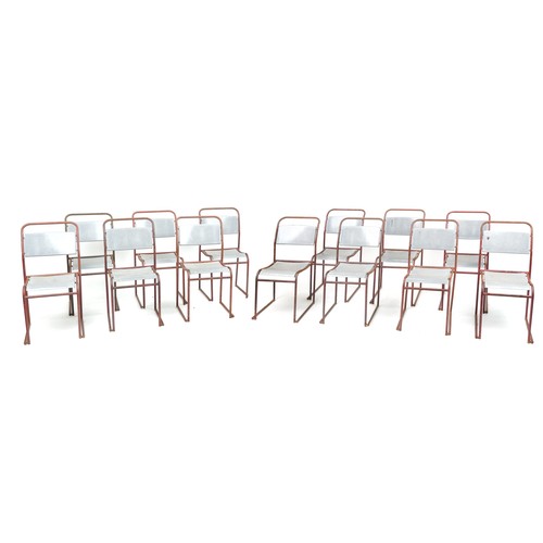 1103 - Thirteen industrial metal framed stacking chairs, each 85cm high