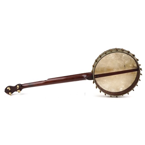 1206 - A C Fairbanks & Co mahogany and rosewood four string banjo with mother of pearl inlay, 88cm in lengt... 