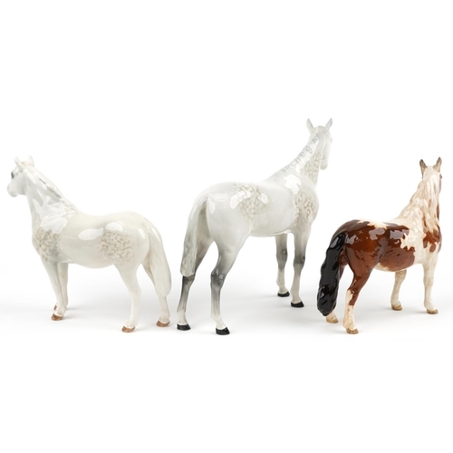 683 - Three Beswick collectable horses comprising pinto skewbald pony, two dapple grey examples, one inscr... 