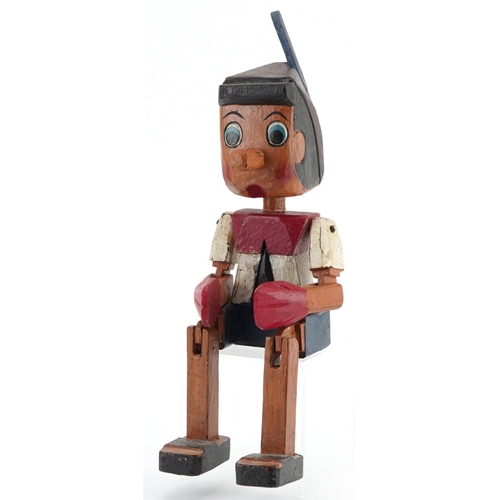 1623 - Hand painted carved wood figure of Pinocchio with jointed arms and legs, 35cm high