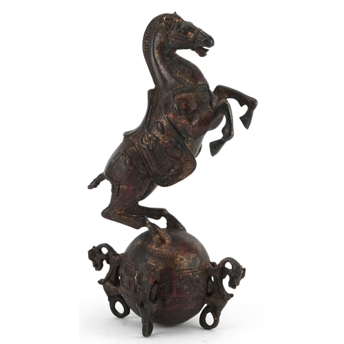 1320 - Chinese partially gilt and red lacquered bronze of a rearing horse, 22.5cm high