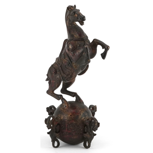 1320 - Chinese partially gilt and red lacquered bronze of a rearing horse, 22.5cm high