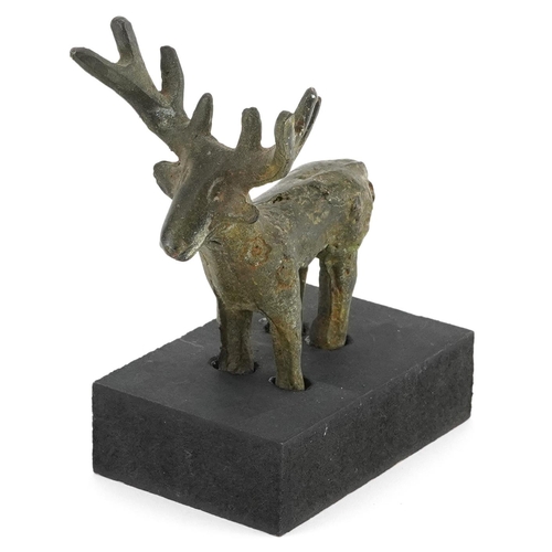 1530 - Middle Eastern Luristan type bronze of a deer raised on a rectangular black painted wooden base, ove... 