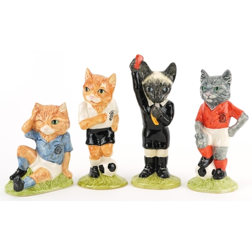 685 - Four sporting interest Beswick cat figures from the Footballing Felines Collection comprising Dribbl... 