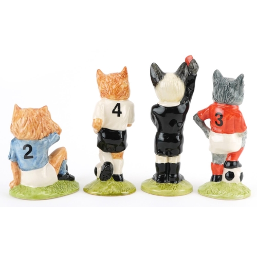 685 - Four sporting interest Beswick cat figures from the Footballing Felines Collection comprising Dribbl... 