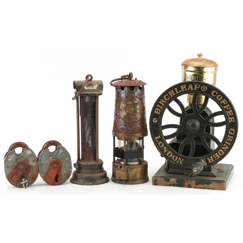 82 - Two early 20th century miner's lamps and a Birchleaf coffee grinder, the largest 31cm high