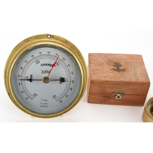 1323 - Shipping interest bulk head Sestrel wall barometer and a naval interest compass with hardwood case, ... 