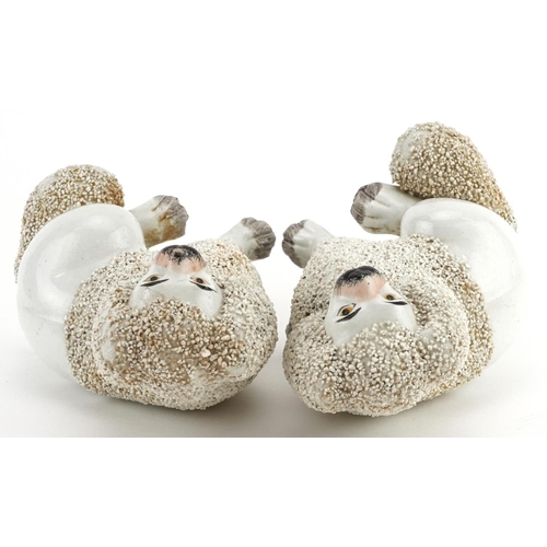 477 - Pair of Victorian Staffordshire pottery Poodles, each 14cm high