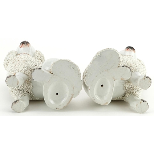 477 - Pair of Victorian Staffordshire pottery Poodles, each 14cm high