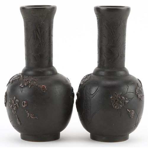 434 - Pair of Japanese bronze vases cast in relief with birds of paradise amongst flowers, each 12cm high