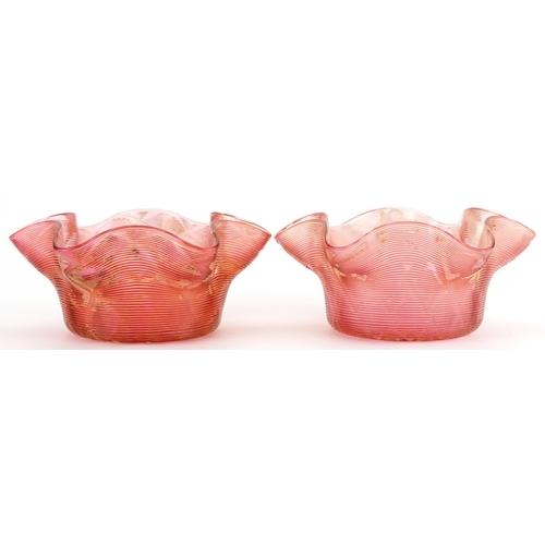 1334 - Pair of Art Nouveau iridescent peach glass finger bowls, each 14cm in diameter