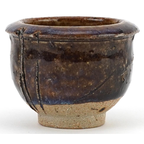 1538 - Japanese studio pottery Yunomi tea bowl having a purply brown glaze, 8.5cm in diameter