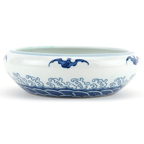 1335 - Chinese blue and white porcelain bowl decorated with bats above crashing waves, six figure character... 