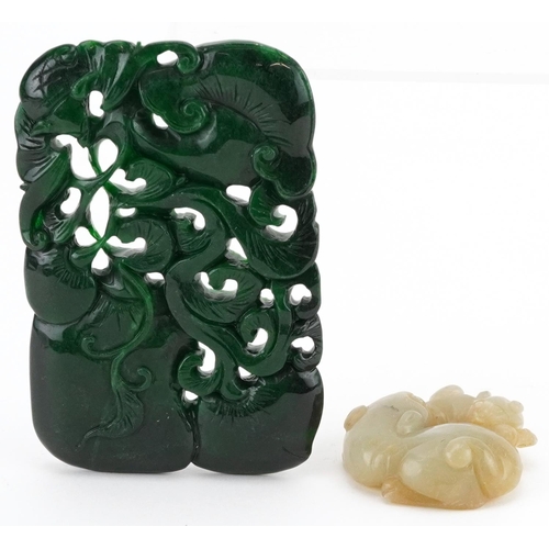 560 - Two jade carvings including a green panel carved with fruit, the largest 11cm x 7.5cm