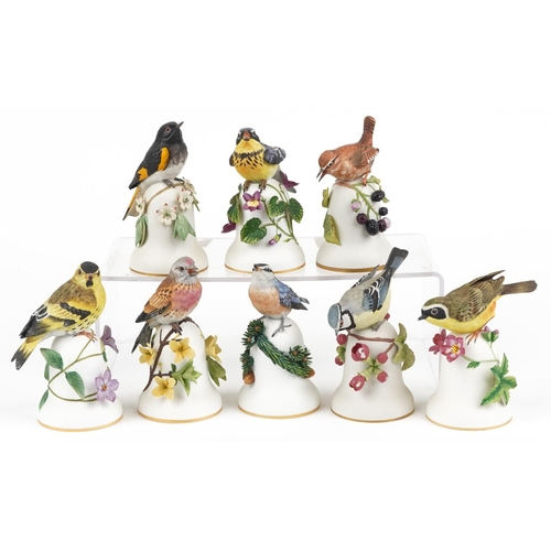 694 - Peter Barrett for Franklin Porcelain, eight hand painted porcelain bird table bells including The En... 