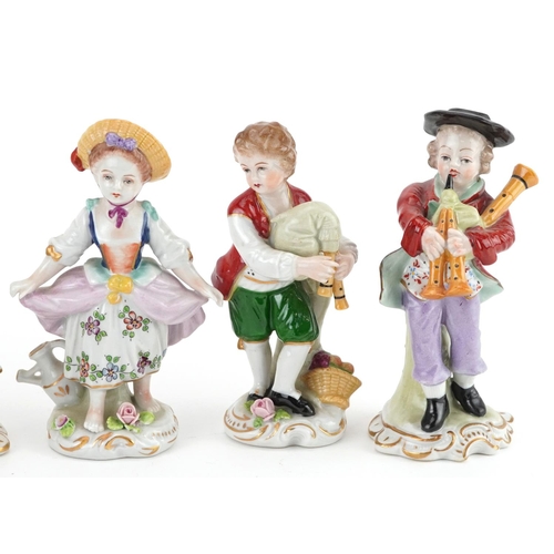 419 - German porcelain comprising four Dresden figurines and a lace figurine in the form of a female on se... 