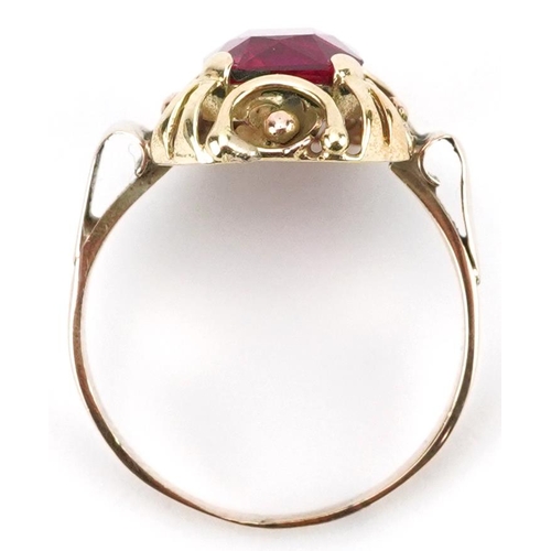 2218 - Continental unmarked gold ruby ring with pierced flower head setting, tests as 15ct gold, the ruby a... 