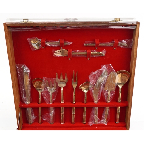 732 - Thai twelve place canteen of bronze cutlery with simulated bamboo handles, the canteen 46cm wide