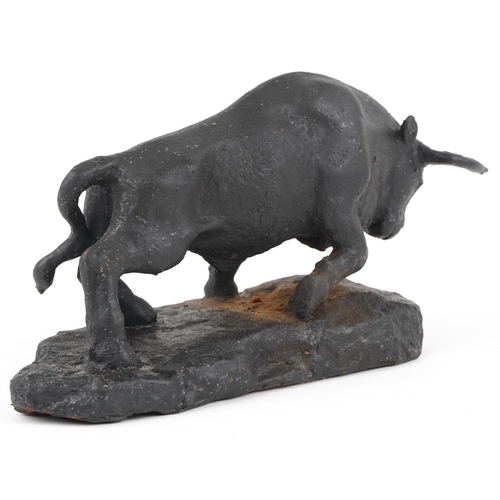 279 - Black painted cast iron sculpture of a raging bull, 30.5cm in length