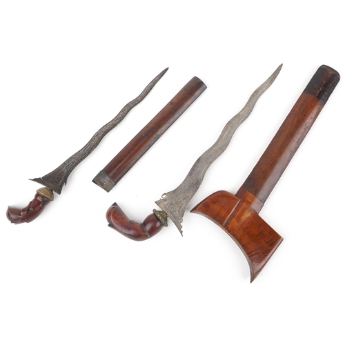 1914 - Two Javanese Kris daggers with hardwood sheaths, handles and watered steel blades, 44cm in length