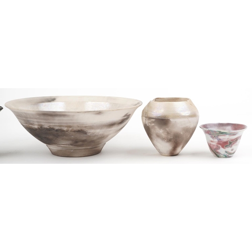 108 - Contemporary raku glazed studio pottery including a centre bowl and two vases having an abstract des... 