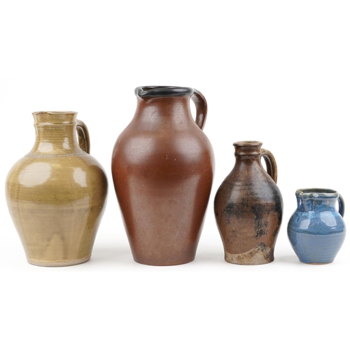 1295 - Three studio pottery jugs and a flagon including a blue glazed example by Winchcombe, the largest 40... 