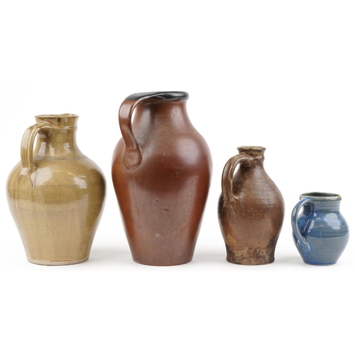 1295 - Three studio pottery jugs and a flagon including a blue glazed example by Winchcombe, the largest 40... 