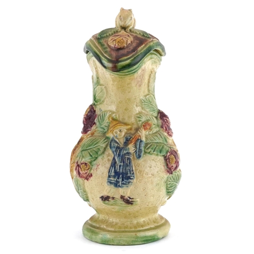 216 - 19th century Majolica lidded jug with handle in the form of a Greyhound, decorated in relief with a ... 
