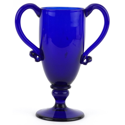 226 - Antique Bristol Blue pedestal cup with twin handles, 16cm high