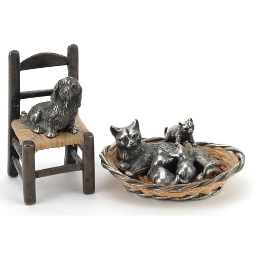 306 - Two miniature silver and wicker animals comprising cat in a basket with kittens and a dog seated on ... 