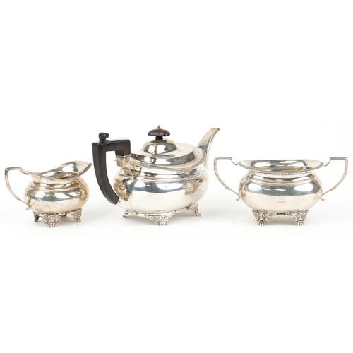 35 - Daniel & John Wellby, Victorian silver three piece tea service, the teapot with wooden handle and kn... 