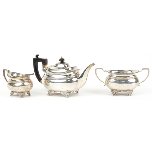 35 - Daniel & John Wellby, Victorian silver three piece tea service, the teapot with wooden handle and kn... 