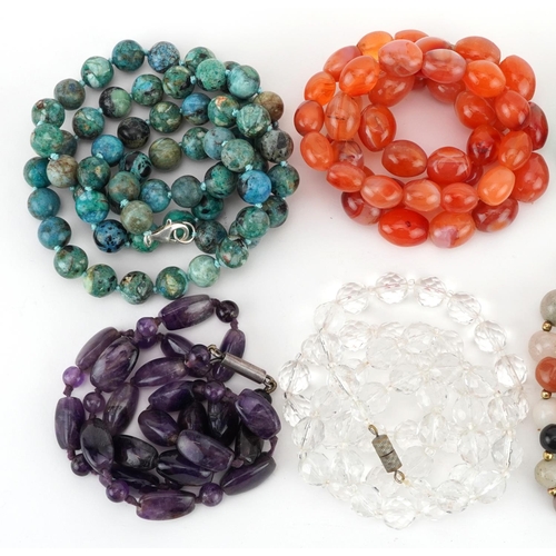 2799 - Eight crystal and semi precious stone necklaces including amethyst, carnelian and jade, the largest ... 