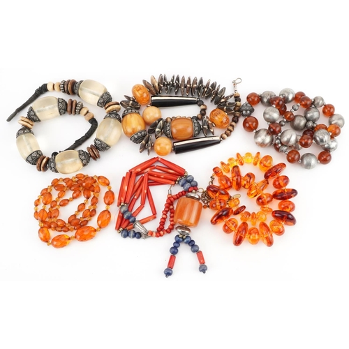 2809 - Six Asian necklaces including natural amber, amber coloured facetted beads and coral