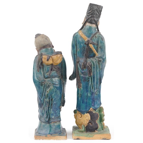 346 - Pair of Chinese porcelain figures having sancai type glazes including one of an elder holding a frui... 