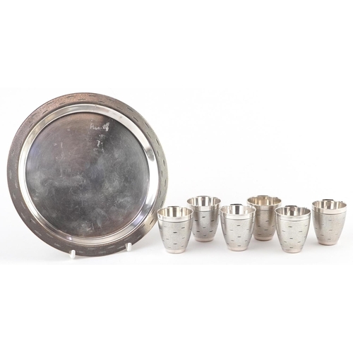 523 - Set of six Modernist chrome shot glasses on circular tray, largest 16cm in diameter