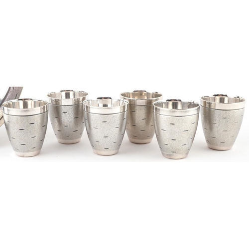 523 - Set of six Modernist chrome shot glasses on circular tray, largest 16cm in diameter