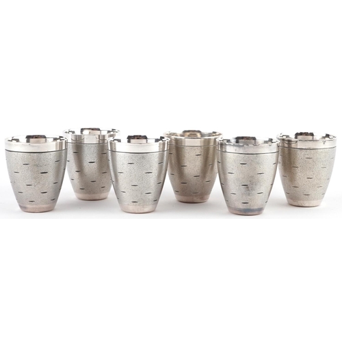 523 - Set of six Modernist chrome shot glasses on circular tray, largest 16cm in diameter