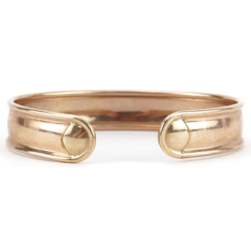 2219 - 9ct gold floral engraved cuff bangle, 6.5cm wide, 9.0g