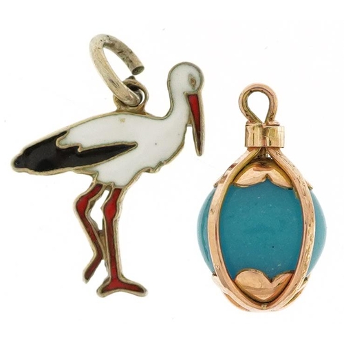 2526 - Two charms comprising Danish sterling silver and enamel stork from Ribe and an unmarked gold caged t... 