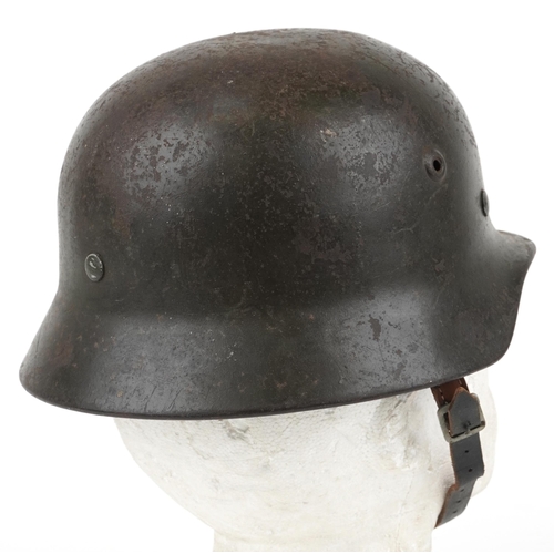 1887 - German military interest tin helmet with leather liner and chin strap, indistinct impressed marks to... 