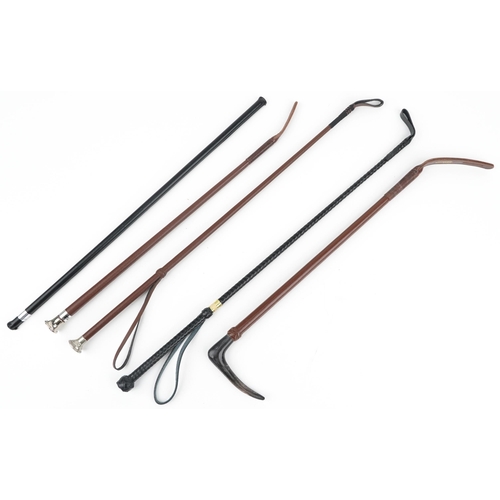 1368 - Five leather riding crops including one with horn handle, the largest 67cm high